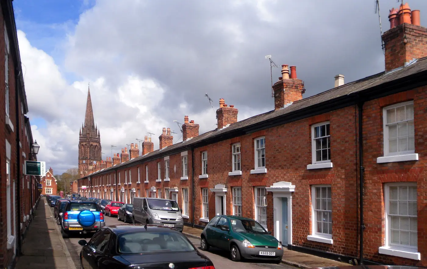 Red-brick Victorian terraced houses on Pyecroft Street, Handbridge, Chester, with the spire of St Mary without-the-Walls behind
