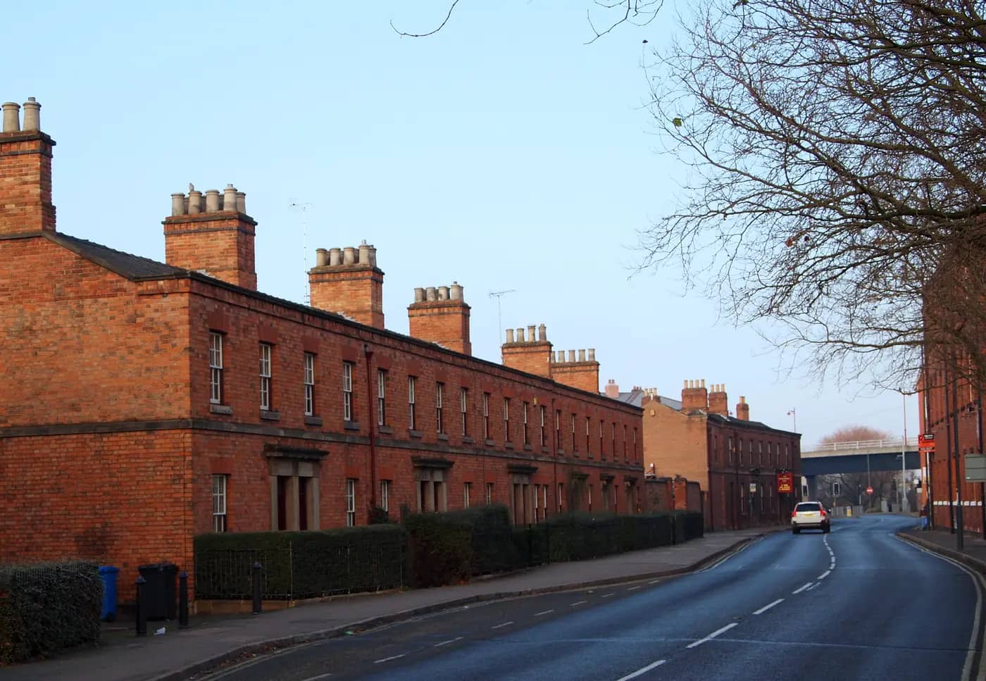 Early Victorian red-brick railway cottages with tall chimneys on Railway Terrace, Derby