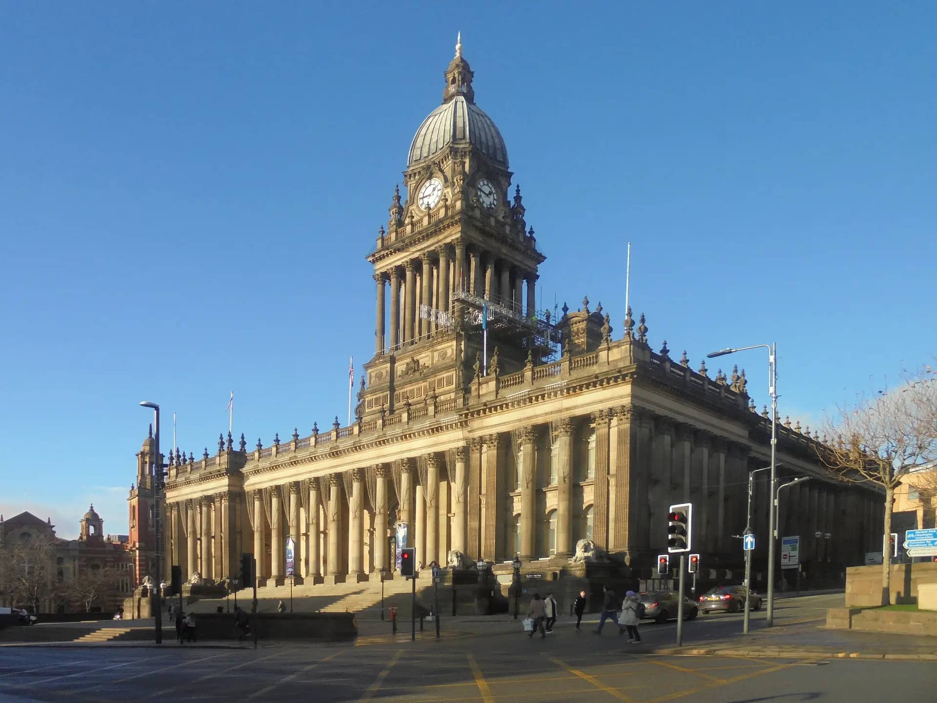 Leeds Town Hall's domed clock tower and colonnade in winter sunshine under a clear blue sky
