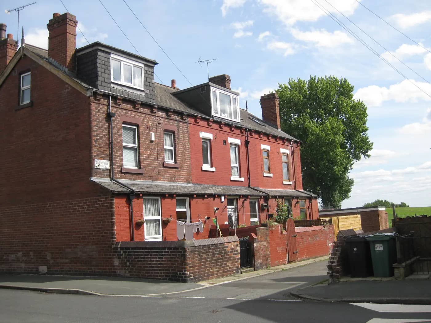 The back of red-brick terraced houses with dormer windows on Back Victoria Avenue, East End Park, Leeds