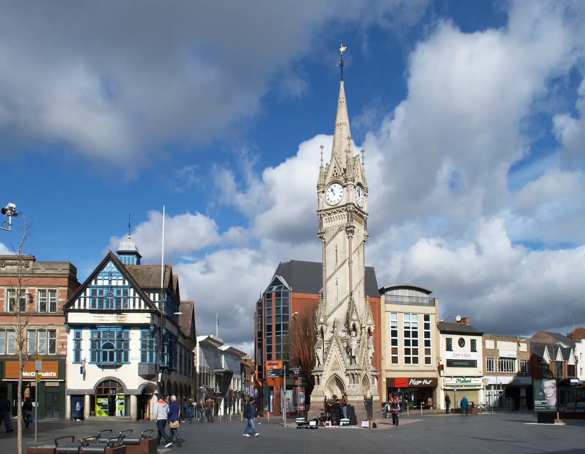 The Haymarket Memorial Clock Tower in Leicester city centre under a blue, cloudy sky