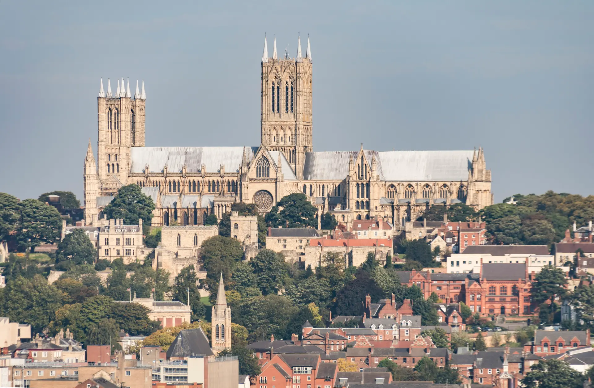 Lincoln Cathedral on the hilltop above the houses and rooftops of uphill Lincoln