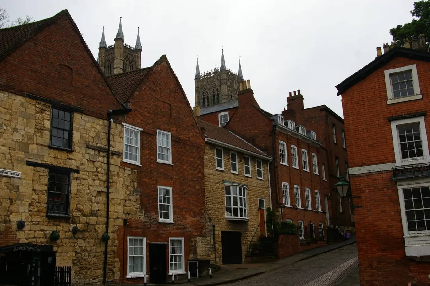 Stone and brick houses on Christ's Hospital Terrace, Lincoln, with the cathedral towers behind