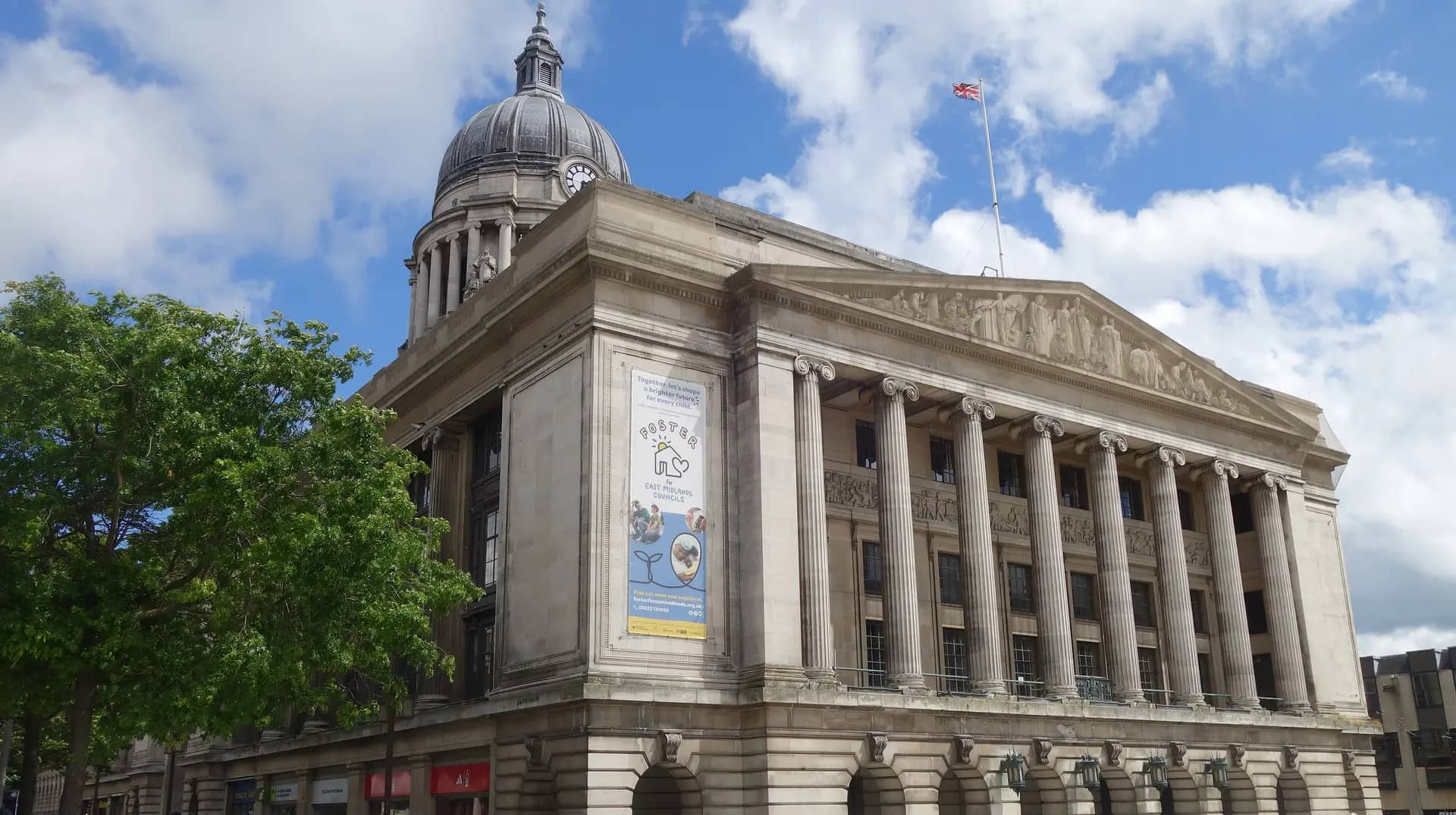 The dome and columned front of Nottingham's Council House on the Old Market Square under a blue, cloudy sky
