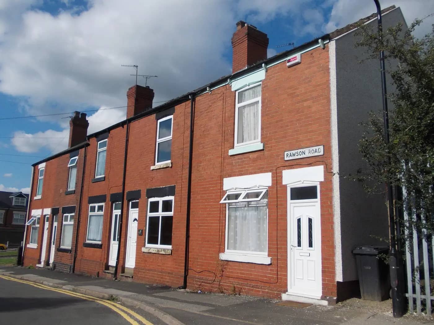 Red-brick terraced houses on Rawson Road, Rotherham, in sunshine
