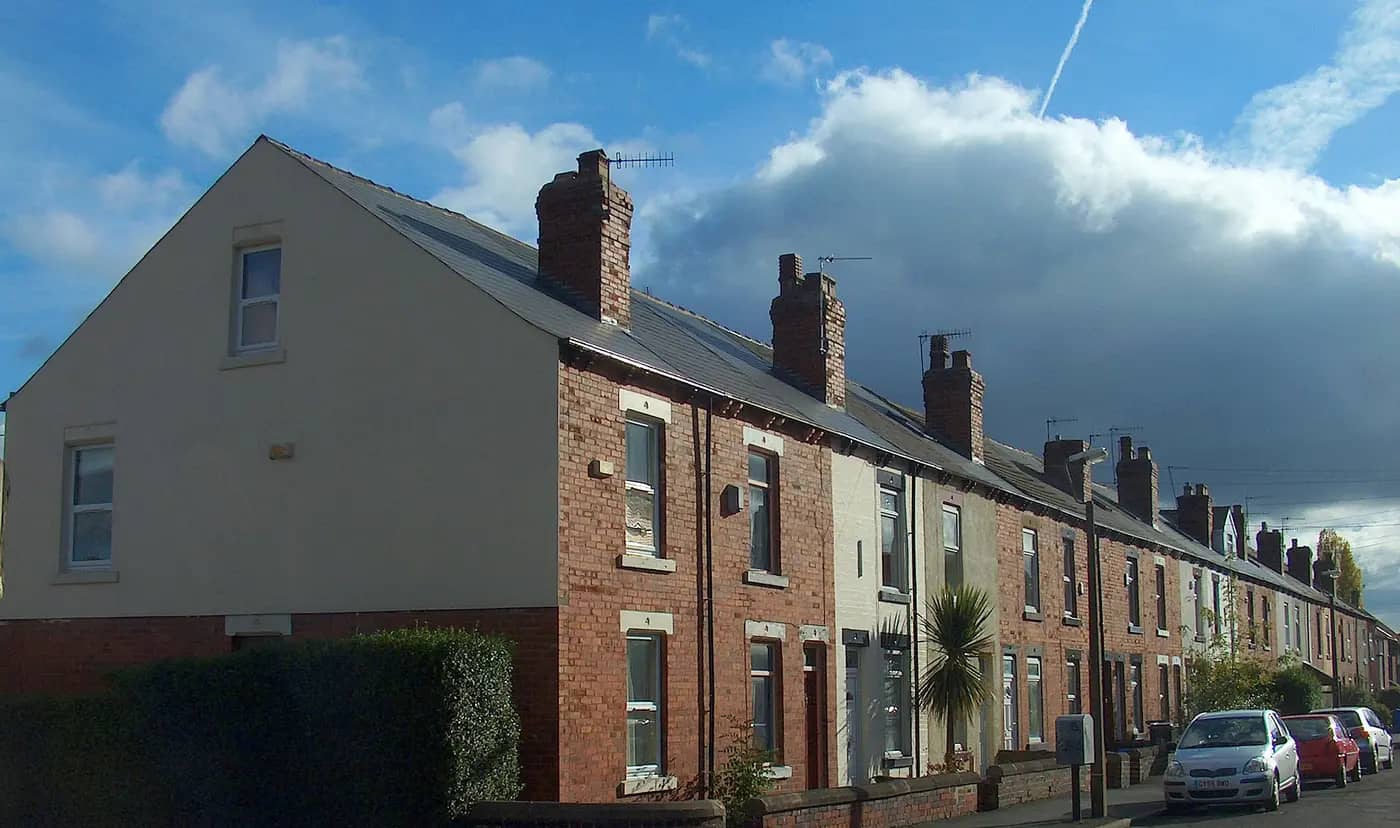 Victorian red-brick terraced houses with tall chimneys on Leamington Street, Crookes, Sheffield, under a blue sky
