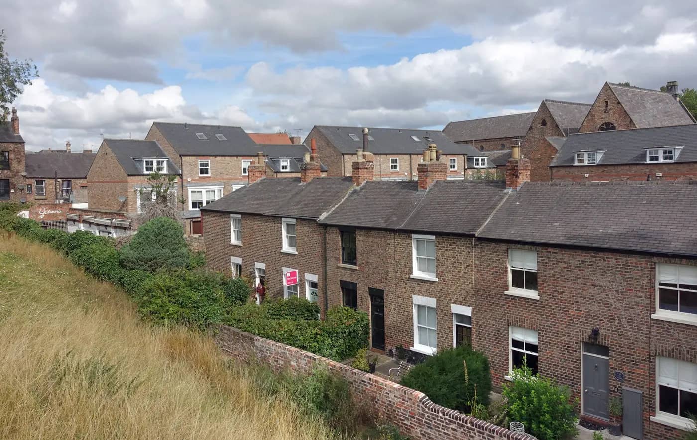 Victorian brick terraced houses on Dewsbury Terrace, York, seen from the city walls