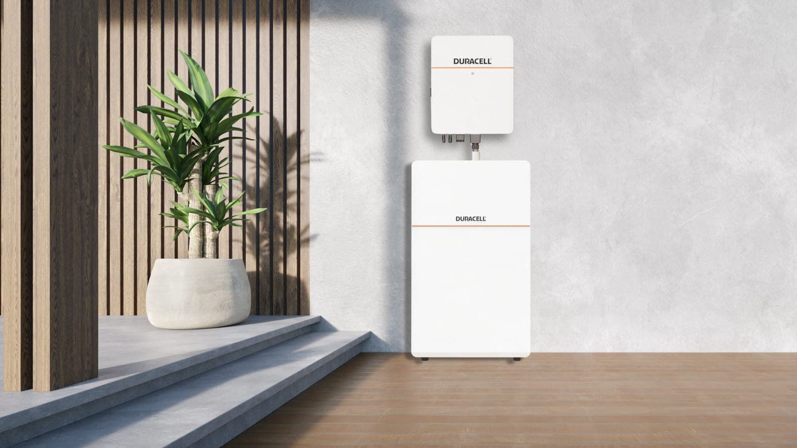 A Duracell Energy battery and inverter on a pale wall beside a potted plant