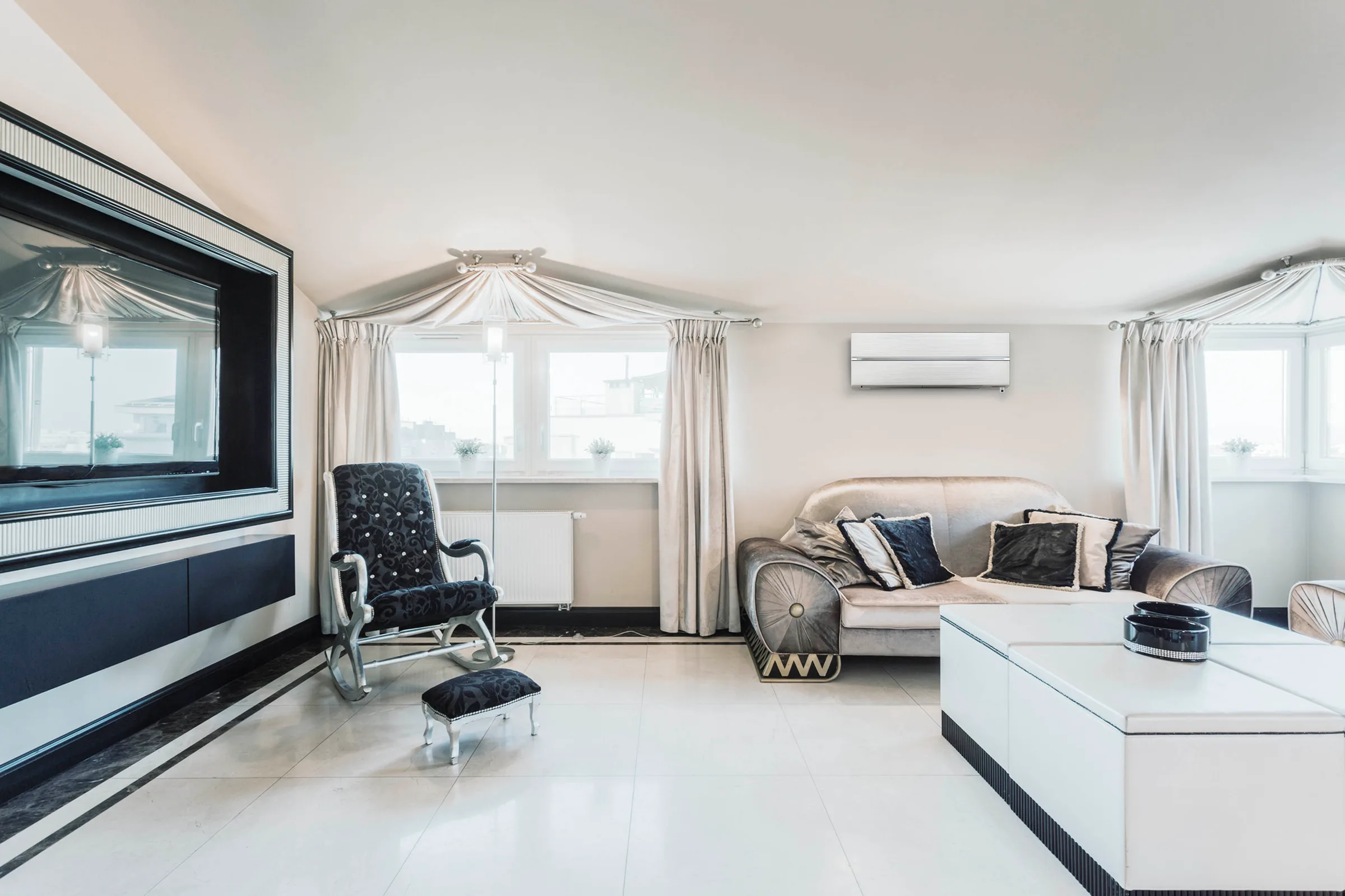 A wall-mounted air conditioning unit high on the wall of a bright living room