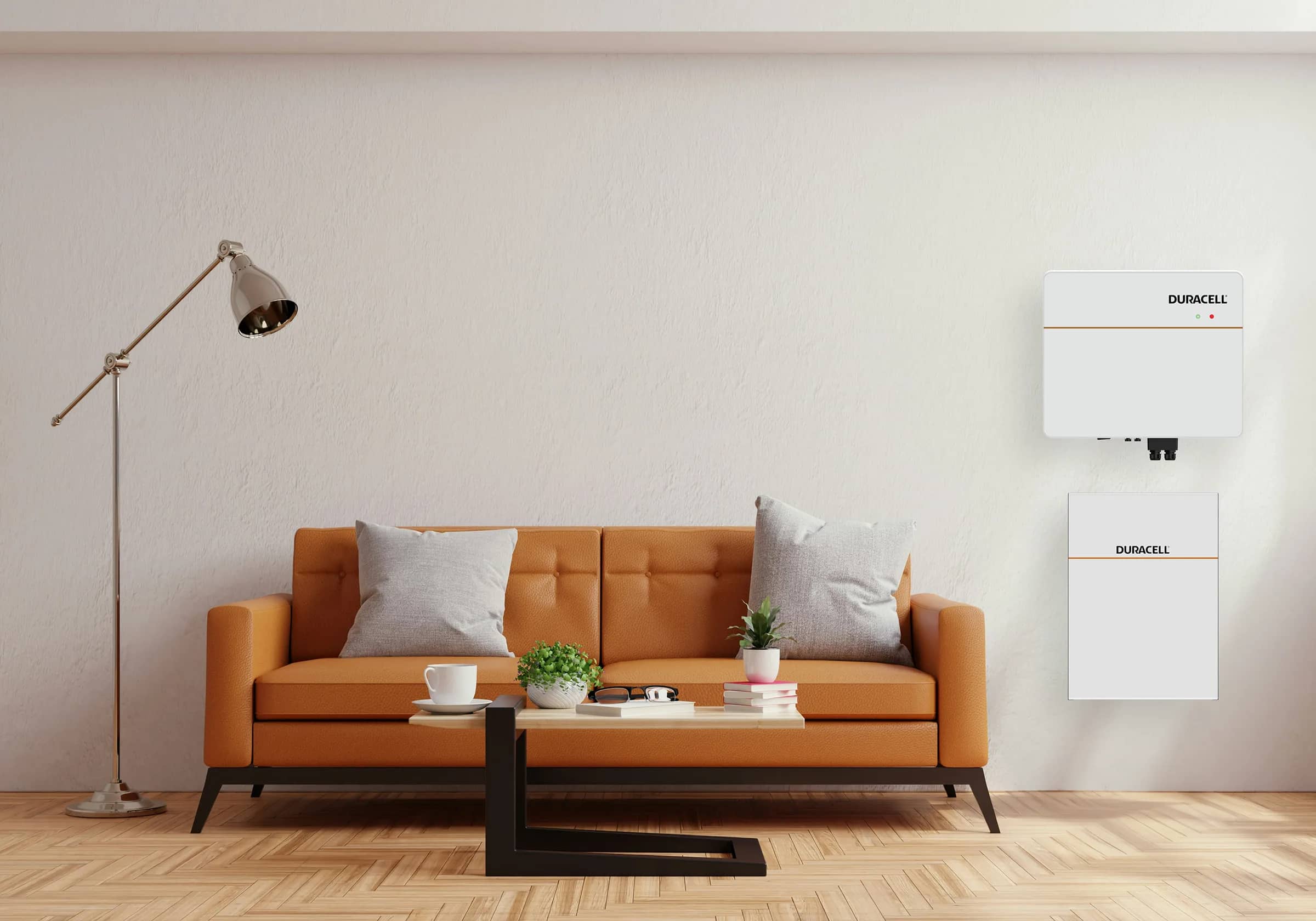 A Duracell Energy battery and inverter on the wall of a living room beside an orange sofa