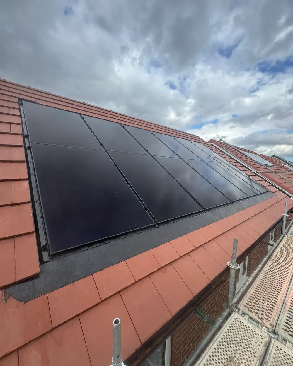 Black in-roof solar panels set flush into a red-tiled roof near Grimsby, fitted by Newpower